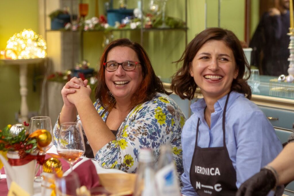 Smiling participants during the final tasting of the"In the Kitchen with the Chef" team-building event